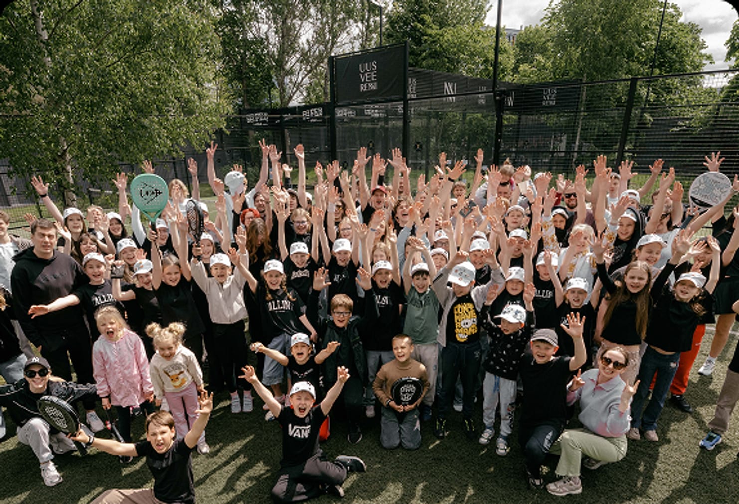 A large group of students and staff gathered outdoors