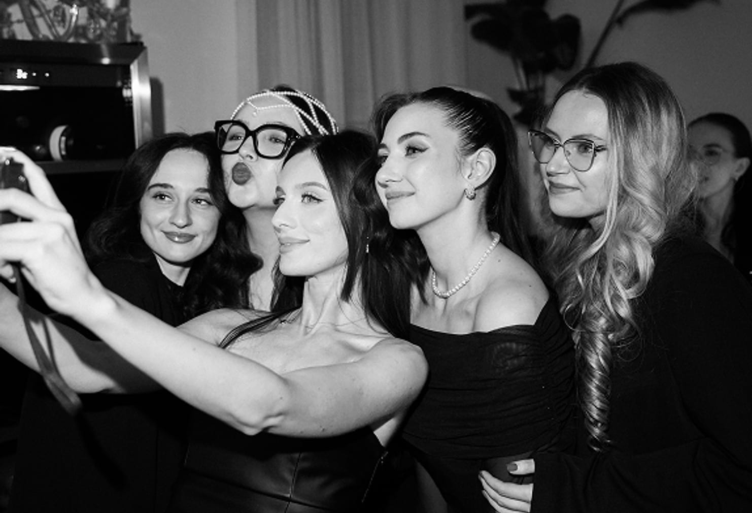 Guests photographing themselves together at a studio party